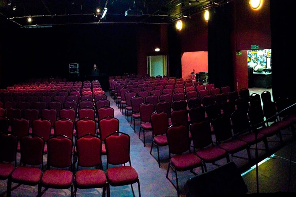 Rows of red theatre seats facing the stage in the Ropetackle Arts Centre auditorium